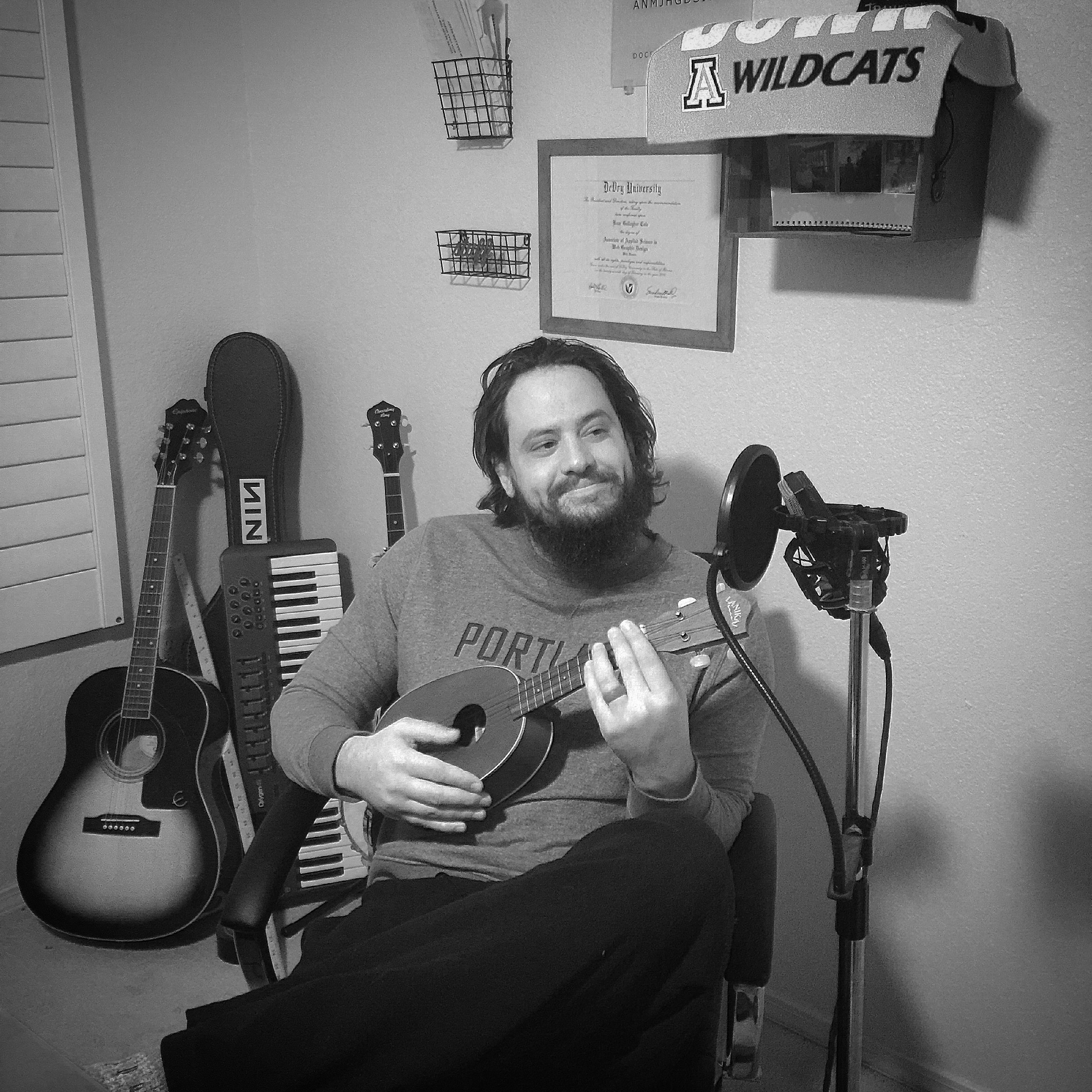 The artist playing ukulele in a home recording space